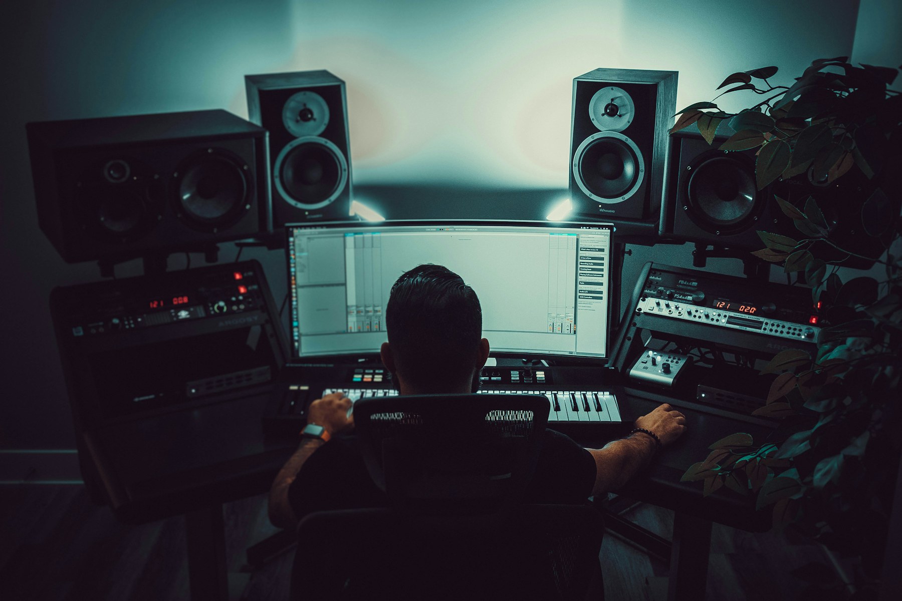 Person working at a computer in a music production studio