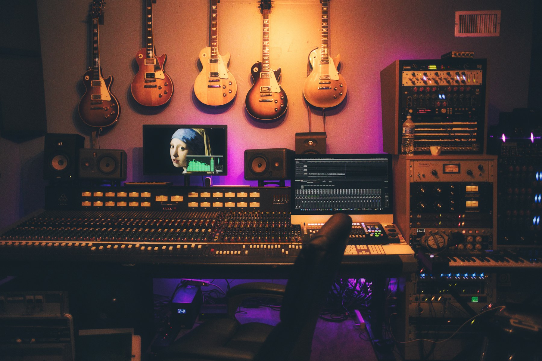 Recording studio with guitars, speakers, and mixing equipment